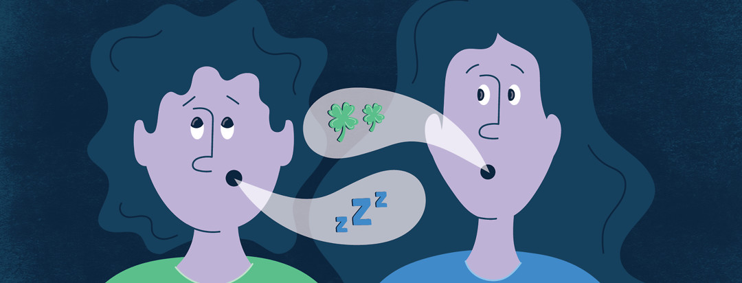 two women have a conversation, one woman looks annoyed and has Zs in her speech bubble and the other woman has four leaf clovers in her speech bubble