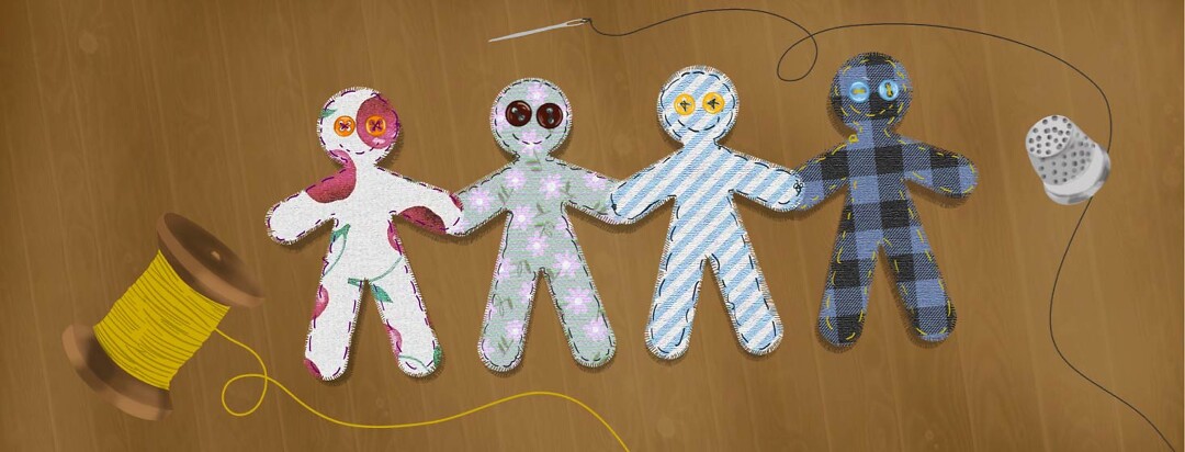 Fabric people cut outs stitched together surrounded by a thimble and spool of thread.
