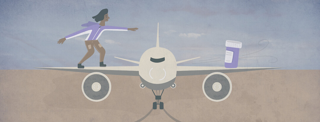 a woman stands on a wing of an airplane and reaches for a bottle of pills balanced on the other wing
