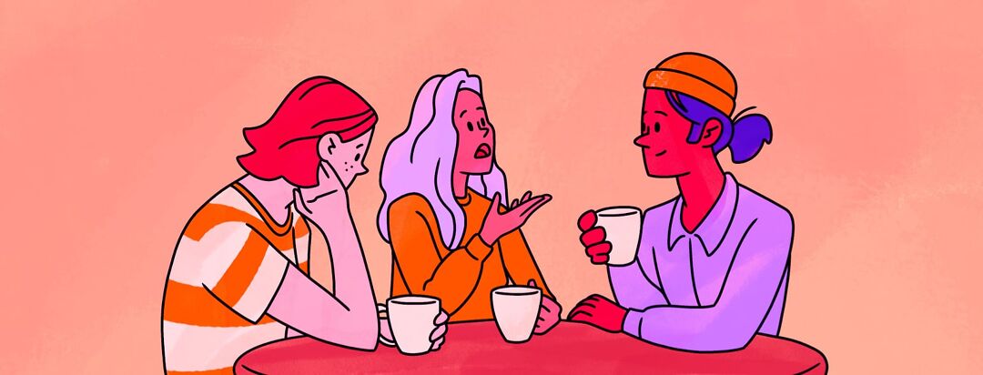 A woman talks with friends over a cup of coffee or tea