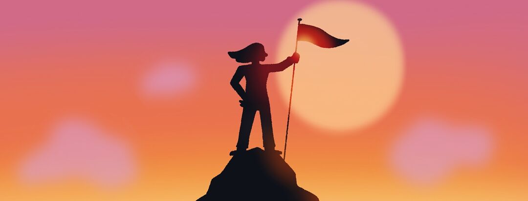 A triumphant person stands on a mountain peak